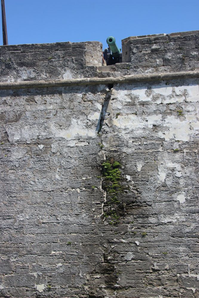 This worrisome if artistic crack is what happens when you flood a moat alongside the fort walls.