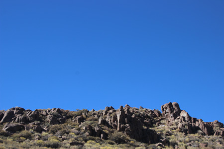 Blue sky and rock pinnacle on the approach to Bodie, CA