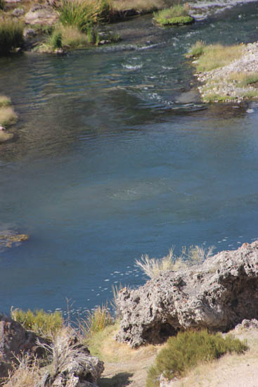 Stream with a fumarole or whirlpool in the center.