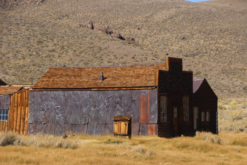 Intact Building, sheathed in copper, against hills and sky.