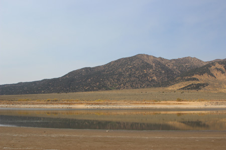 Reflection of hill and landscape in still water.