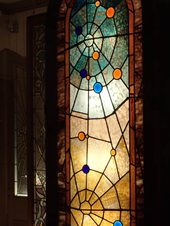 Stained glass, teal, orange, blue, white and gold, a web design with scattered orbs. One of the prettiest web windows.