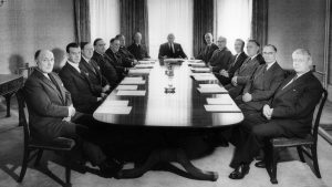Black and white photo white men at a board meeting.
