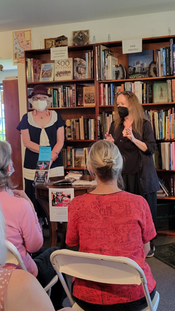 Brandy Mow, on the right, introduces me. Both standing in front of the New Arrives bookcase