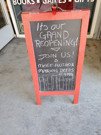 With my name on it! Sandwich board outside Emporium of the Weird. "It's our Grand Reopening." Join us! Meet Author Marion Deeds."